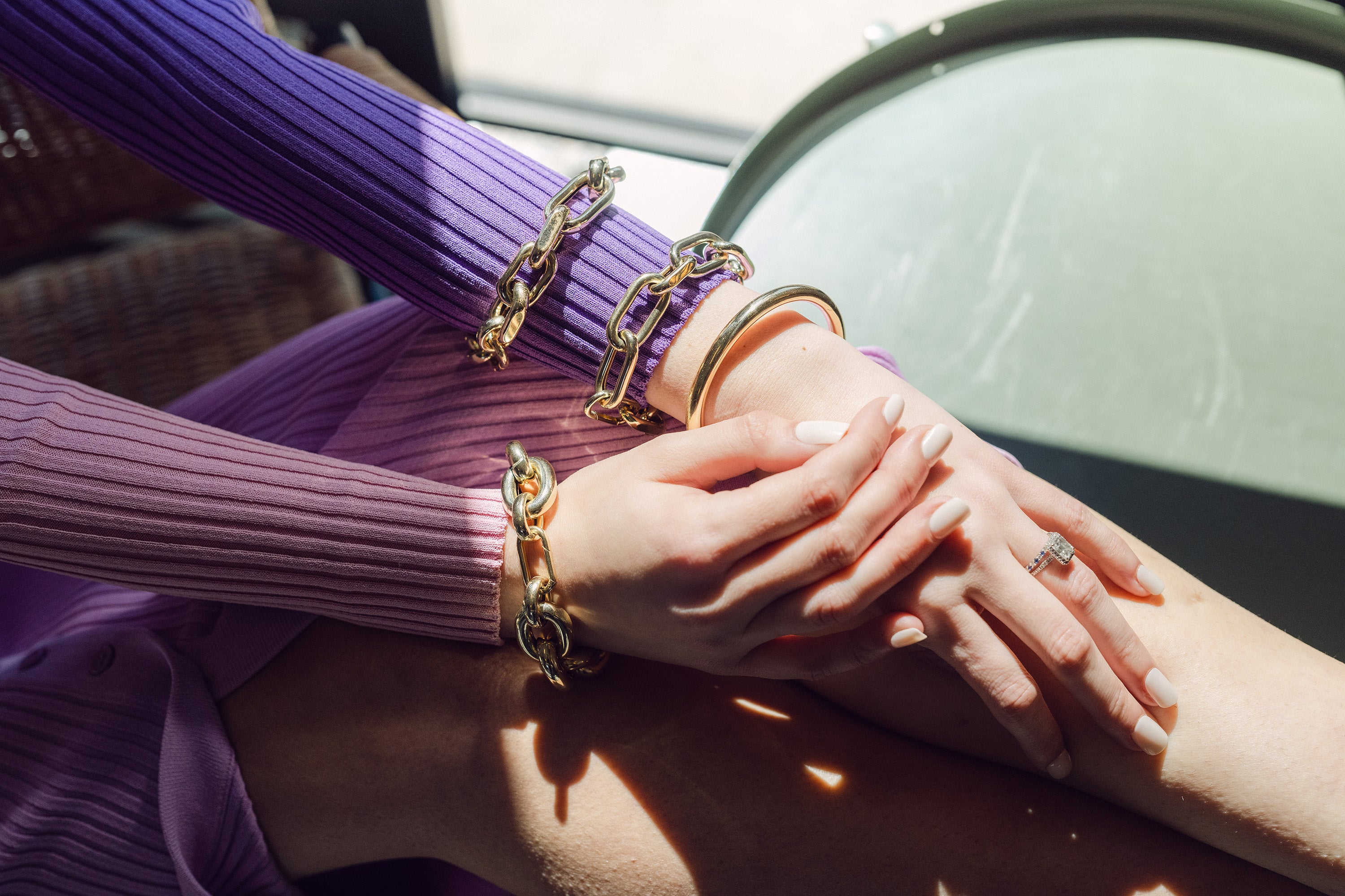 Hands in the sunlight with bracelets and rings